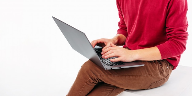 The laptop in men hands on white background, banner