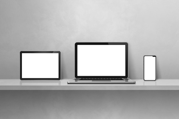 Laptop mobile phone and digital tablet pc on grey wall shelf Horizontal background