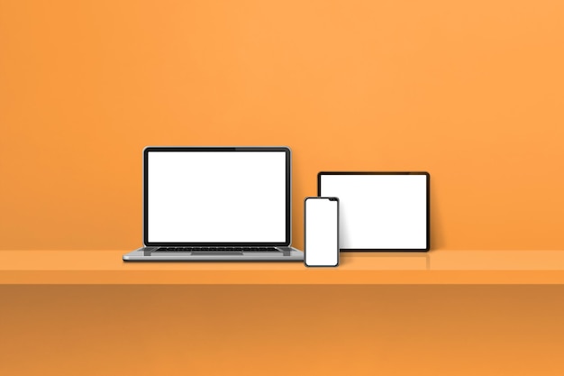 Laptop mobile phone and digital tablet pc on orange wall shelf Horizontal background