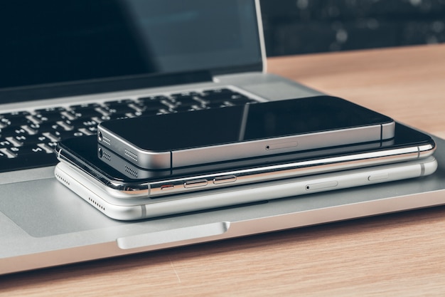 Laptop and mobile phone on the table. Workspace concept.