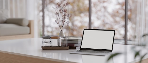 Laptop mockup and decor on modern luxury white coffee table in comfortable living room