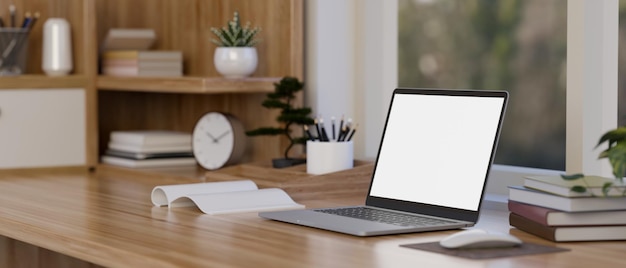 Laptop mockup is on the wooden table with decor against the window minimalist workspace