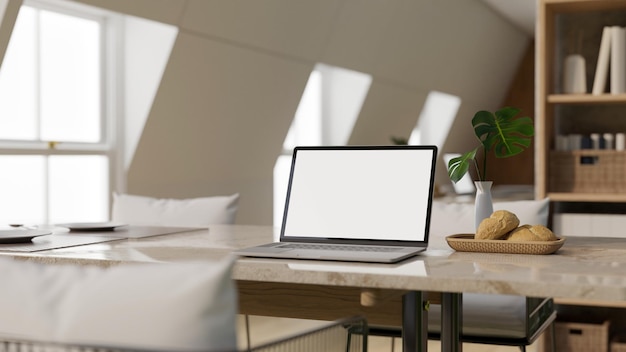 A laptop mockup on a luxury dining table in modern bright dining room