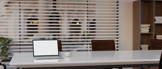 A laptop mockup on a meeting table in modern meeting room