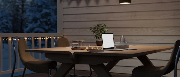 Laptop mockup on an outdoor dining table at terrace at night