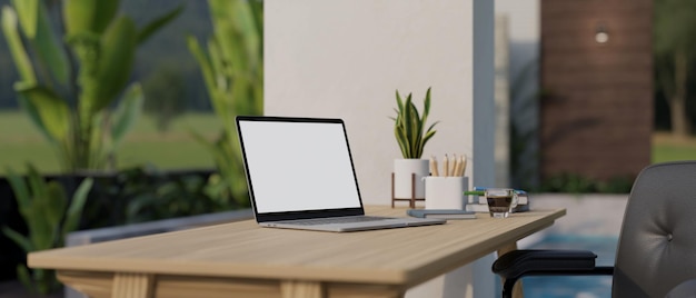 A laptop mockup on a wooden table against the large glass window in a modern room