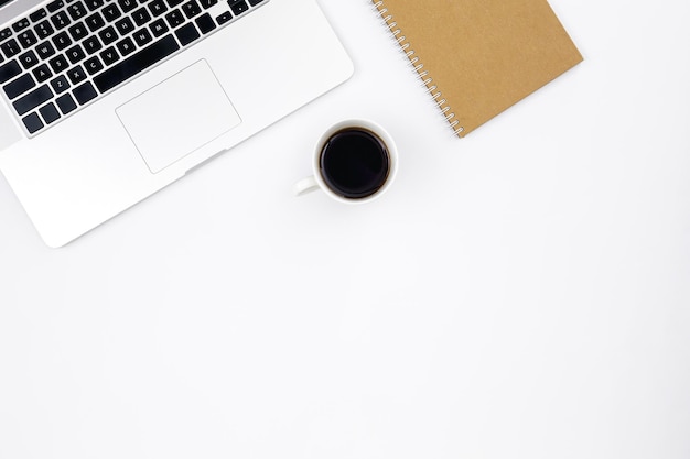 Laptop notebook and a cup of black coffee on a white background top view