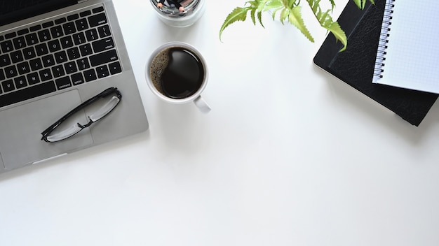 laptop, notebooks and coffee cup on white background.