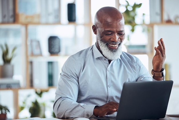 Laptop online meeting and African businessman in the office in a virtual corporate discussion Happy leadership and senior male employee talking on video call or webinar with computer in workplace