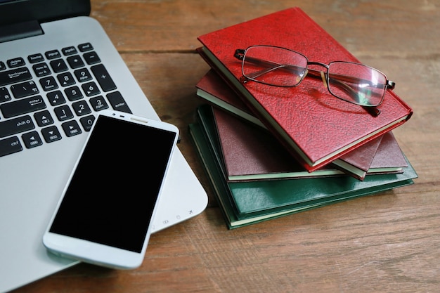 Laptop phone book on wooden table