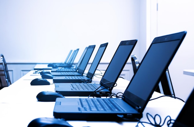 Laptop row on table in training room