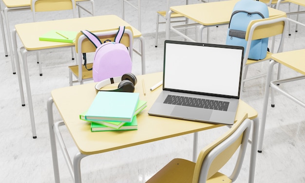 Photo laptop on a school desk in a classroom with books and supplies around