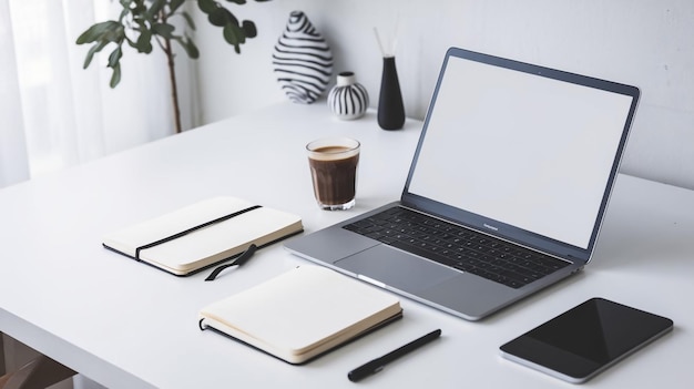 Photo a laptop sits on a white desk with a cup of coffee and a book on it