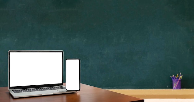 Laptop smartphone blank screen lies on wooden table for foreground Blackboard is Empty Education is important for everyone because it helps to succeed To stimulate teaching