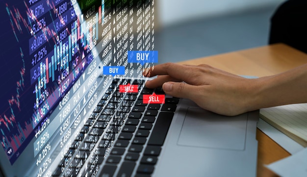 laptop and stock market graph