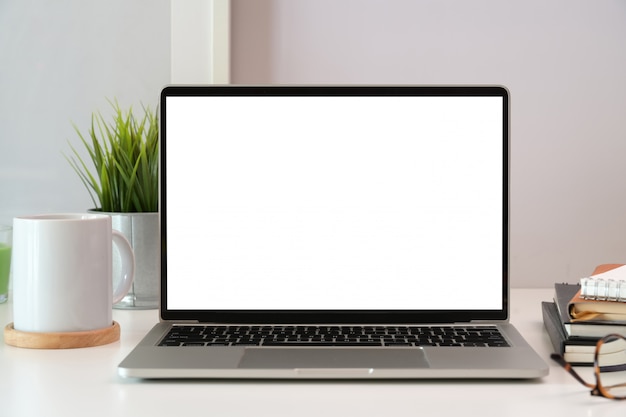 Laptop on white wooden business workspace desk