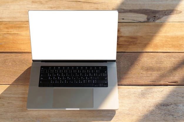 Laptop with black blank screen on a wooden desk