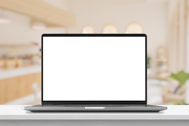 Laptop with blank screen on marble table with cafe coffee shop blur background