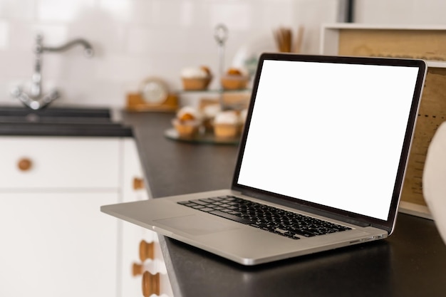 Laptop with blank screen on table.