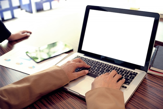 Laptop with Mock up blank screen on wooden table in front of coffeeshop cafe space for text