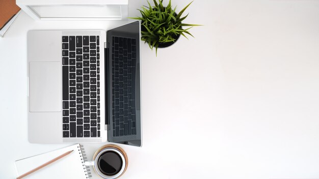 Photo laptop with office accessories on wooden workspace table and copy space