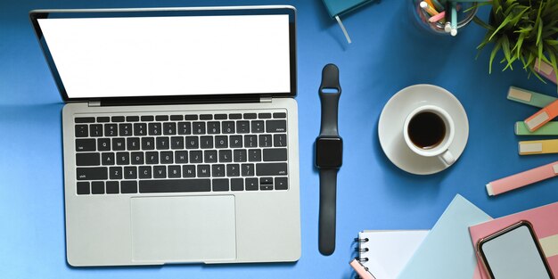 Laptop with white blank screen and a watch