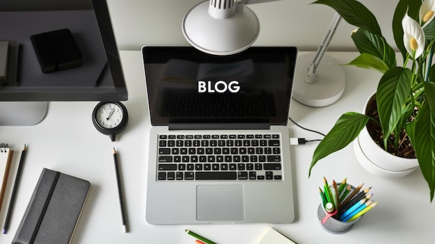 Photo a laptop with the word blog on the screen is placed on a desk surrounded by stationery and plants