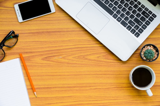 laptop on wooden table with coffee cup