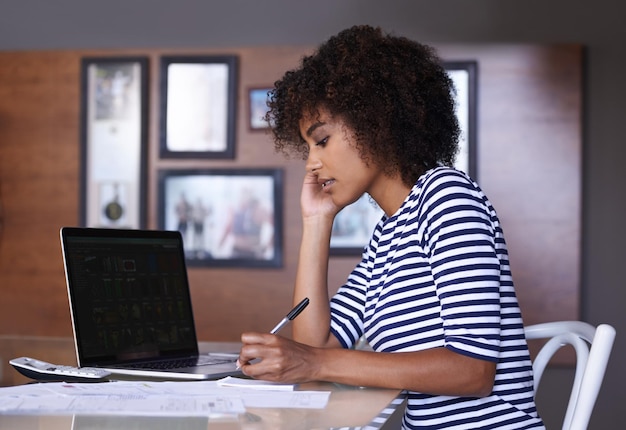 Laptop writing and woman with work from home budget financial management and taxes paperwork at desk Focus research and calculator of african person on computer screen notes or finance documents