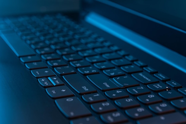 Laptops keyboard in the night concept programming and it industry