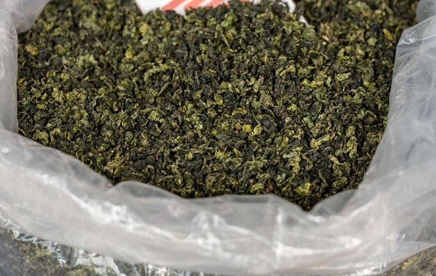 Large bag of green tea leaves drying inside Tulou in Fujian Province in China