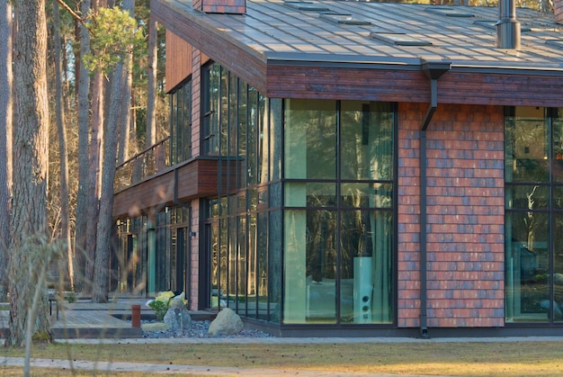 A large beautiful and stylish house with large windows in the woods