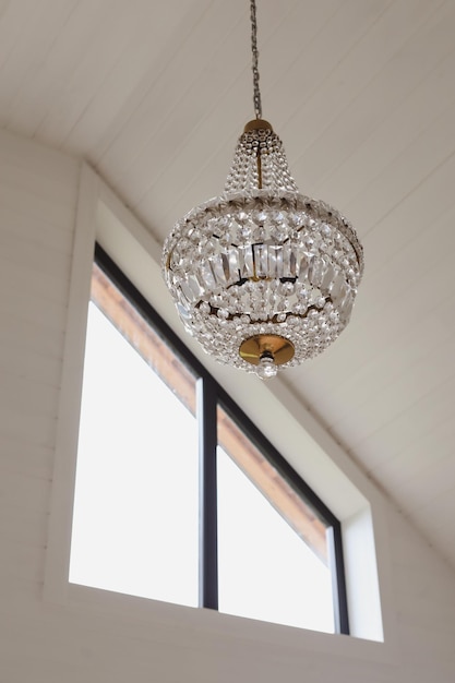 Large beautiful vintage crystal chandelier in a light room