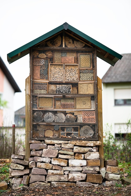 Large and beautiful wood and stone insect hotel created to provide shelter for insects like bees