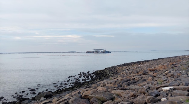 a large boat is in the water and is in the background