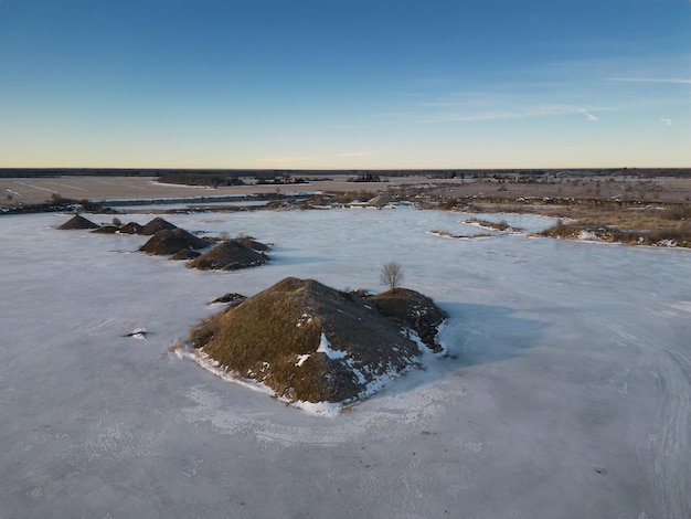 A large body of water with a few small rocks on it.