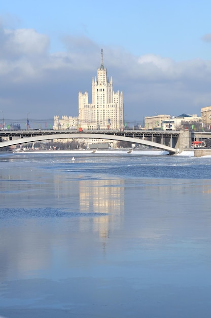 A large building is reflected in the water.