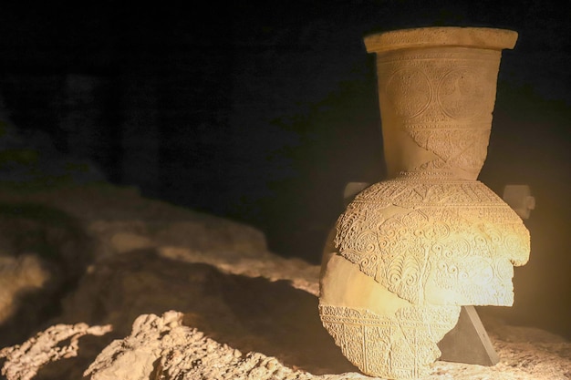 A large clay pot with a lace on the bottom.