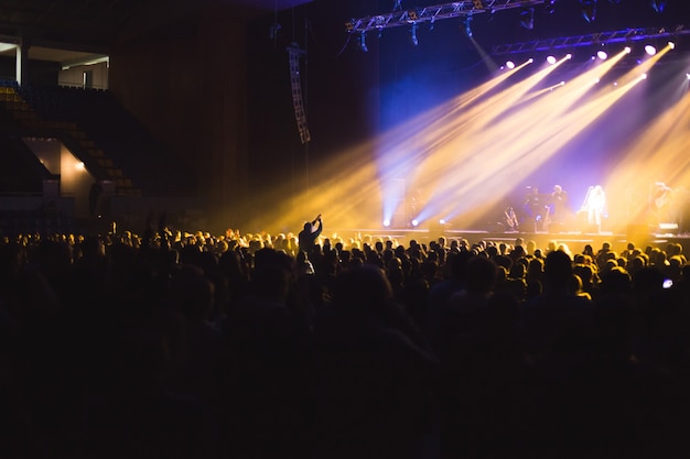 Large concert hall filled with spectators before the stage.