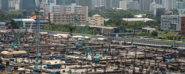 Large construction site with heavy construction machinery in metropolis