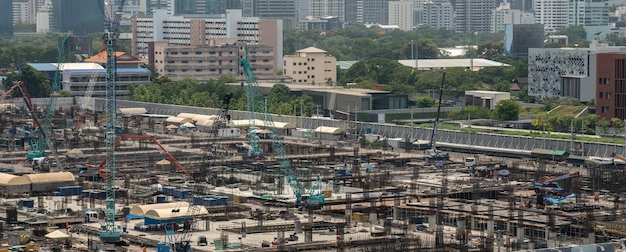 Large construction site with heavy construction machinery in metropolis