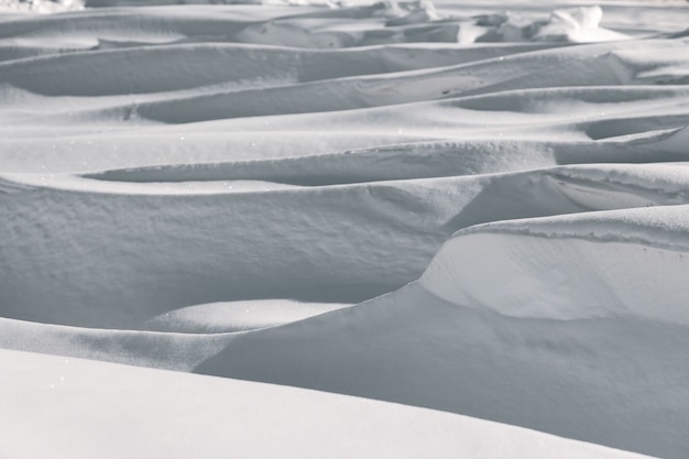 Large deep snowdrifts in winter landscape.