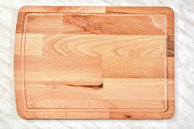 Large empty wooden kitchen cutting board made of birch wood.