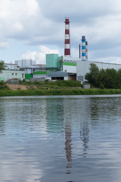 A large factory is located on the river bank.