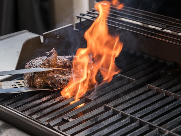 Large fillet of beef flaming on barbeque