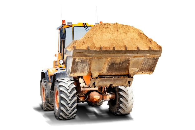 A large front loader transports sand in a bucket at a construction site Transportation of bulk materials Isolated loader on a white background