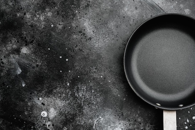 Large frying pan with copy space for text or food with copy space for text or food top view flat lay on black dark stone table background