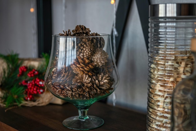 Large glass vase with pine cones Natural Decorating for Christmas New year celebration concept