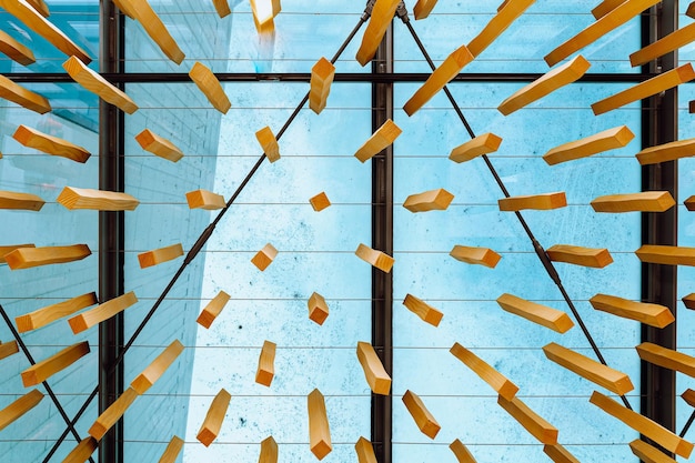 A large glass window with a blue sky behind it.