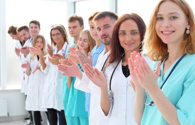 Large group of doctors standing in a row and applauding